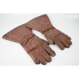 A pair of leather motorbike gauntlets.