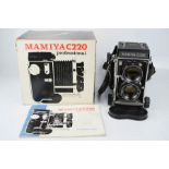 A Professional Mamiya C220 Japanese camera together with the original box and instruction manual.