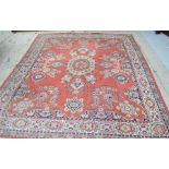 A large rug with red ground, 250 by 300cm.