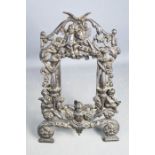 An antique French cast iron photo frame, cast with cherubs and scrollwork.