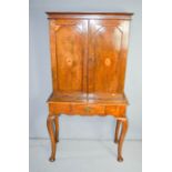 A late 18th / early 19th century oak cupboard, with marquetry inlaid decoration and interior