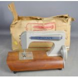 A vintage Grain toy sewing machine with box.