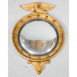 A 19th century porthole mirror, with eagle surmount, 70cm high by 40 wide.