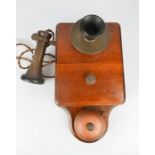 A vintage telephone on wooden backing plate.