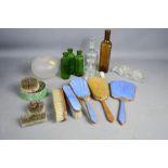 A group of vintage medicine bottles, enamel brush set, and other items