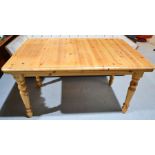 A Pine extending dining table 140 by 90cm.