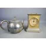 A silver plated teapot and a carriage clock.