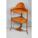 A late Georgian mahogany corner washstand with shaped frieze and fitted drawer.