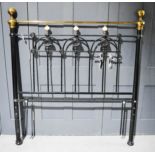 A Victorian style bed head with brass finials.