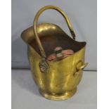 A copper coal scuttle and pair of bellows.