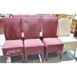 Seven Lloyd Loom chairs in red, one cream.