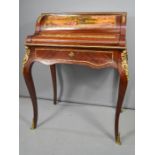 A French style mahogany marquetry bureau, with fitted interior, with a rising top, depicting a man