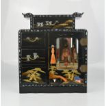 A Chinese black lacquered musical jewellery cabinet.
