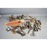 A group of mixed tools, including rules, opera glasses, brassware and other items.
