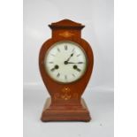 A mahogany mantle clock, inlaid with decoration.