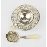 A silver tea strainer embossed with possums, stamped silver, together with a silver and mother of