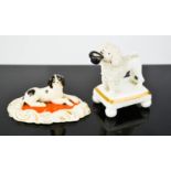 Two 19th century Staffordshire dogs; one seated spaniel and a poodle with top hat, 7½cm high.