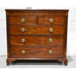 A Regency mahogany chest of two over three long graduated drawers, with marquetry inlaid ovals,