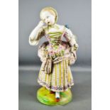 A large 19th century Meissen style German figure of a girl in 18th century clothes and holding