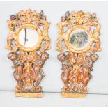 A pair of 17th century giltwood looking glasses, carved with cherubs and scrollwork. 54.5 cms tall