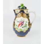An 18th century French Sevres type jug and cover, the body depicting a peacock, blue ground