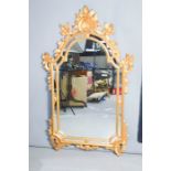 A large Italian style giltwood wall mirror, 140 by 83cm.