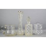 A group of glass and crystalware, including a cut glass decanter, crystal jar, and a stem vase