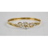 A 9ct gold, opal and diamond floral bangle, set in a floral spray, 10.7g.