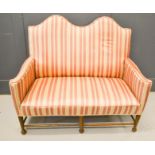 A Regency period two seater camel back settee, with striped upholstery. 127cms long x 71cms deep x