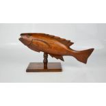 An early treen Pitcairn fish on stand. 15cms tall