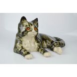 A ceramic cat, signed indistinctly, 35cm wide.