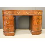 A mahogany kidney shaped desk with red leather top, and two pedestals of four drawers, 134 by 55