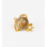 A 15ct gold and nut pendant, set with turquoise eyes, 2cm high. 1.8g