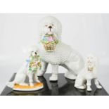 Three porcelain 19th century model poodles, the tallest measure, 18cm high.