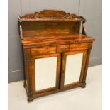 A 19th century rosewood chiffonier, with raised back carved with decoration, and two mirrored