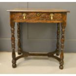 A 17th century oak lowboy, with single drawer decorated with lunette carving, with turned legs and