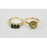 Two 9ct gold rings, a flowerhead cluster ring size Q, and a three stone sapphire ring, size M, 5.