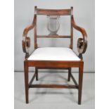 A 19th century mahogany armchair with large scroll arms, and lyre form back.