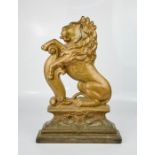 A Victorian cast iron doorstop in the form of a lion, 38cm high.