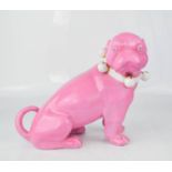 A 20th century ceramic pink glazed model pug dog, with bell collar, 24cm high.