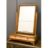 A walnut veneered toilet mirror with two drawers.