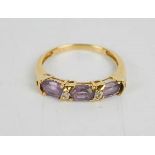 A 10k gold and amethyst ring, three oval cut amethysts, size O, 1.7g.