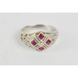 An 18ct white gold ring, set with pink rubies and diamond, size O/P, 5.3g.