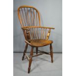 A 19th century elm Windsor armchair, with hoop back, bowed arm rail and H-form stretcher.