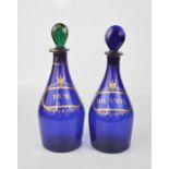 A pair of 19th century blue glass bottles 'Rum' and 'Brandy' detailed in gilding, one with green