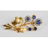 A 9ct gold, diamond and sapphire brooch, finely engraved leaves and flowerheads set with sapphire