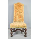 An upholstered 18th century walnut hall chair with high back.