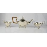 A silver tea set, Birmingham 1938, comprising tea pot 15.28toz, sugar bowl 5.91toz, and milk jug 4.