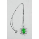 A Tibetan Miau silver turtle pendant and chain, inset with natural Malay green jade.