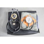 An ETS E Spengler French blood pressure guage, and a stethoscope and bag.